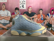 Side profile showing perforated light blue panels, layered midsole sections, and pale yellow outsole accents