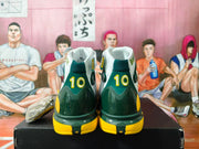 Rear view showing dark green heel sections, yellow outsole accents, and number 10 details.