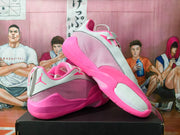 Pair of pink and white Jordan Luka 1 basketball shoes shown from the side and sole.