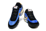 Front view of the Nike sneakers showing black laces, blue toe panels, and gold Swooshes.