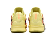 Rear view of yellow Nike Kobe basketball shoes with orange accents.
