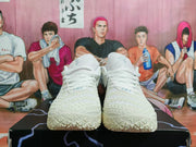 Front view of white Nike shoes with textured uppers and white laces.