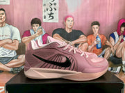 Side view of a pink Nike basketball sneaker showing the black side logo and layered panel detailing.