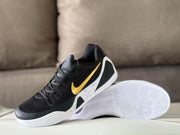 Three-quarter view of one sneaker beside its white patterned outsole.