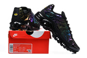 Black Nike Air Max Plus sneakers displayed beside a box label showing a photographed sample size of EU 43.