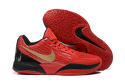 Red basketball shoes shown with the geometric-patterned outsole facing up