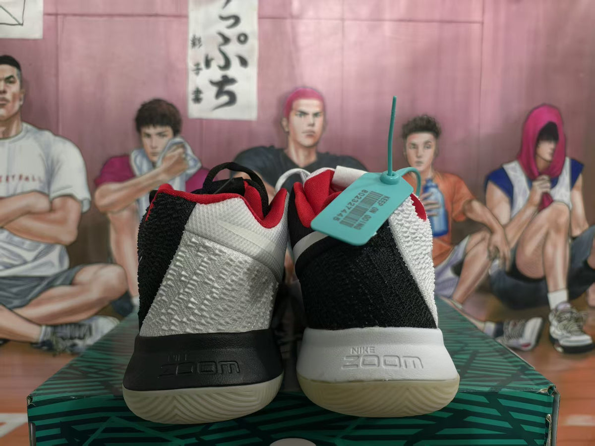 Rear view of mismatched white-and-black basketball sneakers showing contrasting heel panels, red collars, Zoom branding, and textured outsoles.