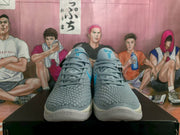 Front view showing the laces, padded tongues, textured toe boxes and blue tongue graphics.