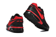 Rear and outsole views of black and red Nike Air Max sneakers with AIR MAX heel lettering.