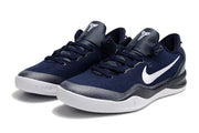 Pair of dark navy Kobe 8 sneakers with white swooshes and white midsoles.