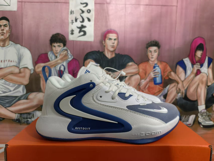 Side view of white and blue Nike basketball sneakers displayed on an orange box.