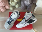 Top and side views showing patterned toe panels, navy laces, and white soles