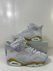 Side view highlighting the perforated panels, white upper, gold midsole accents and visible air unit.