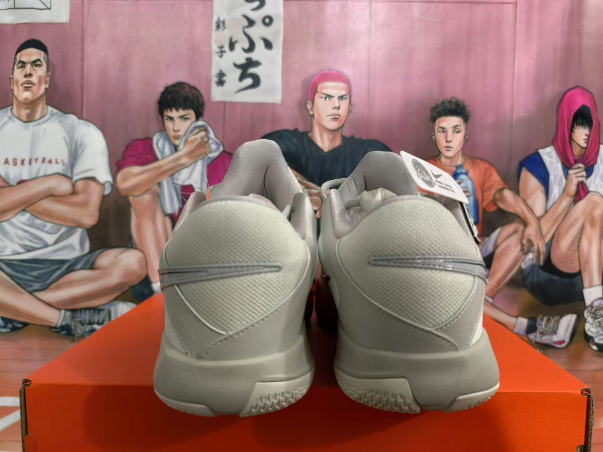 Rear view of white and gray Nike Ja 2 basketball shoes with red accents