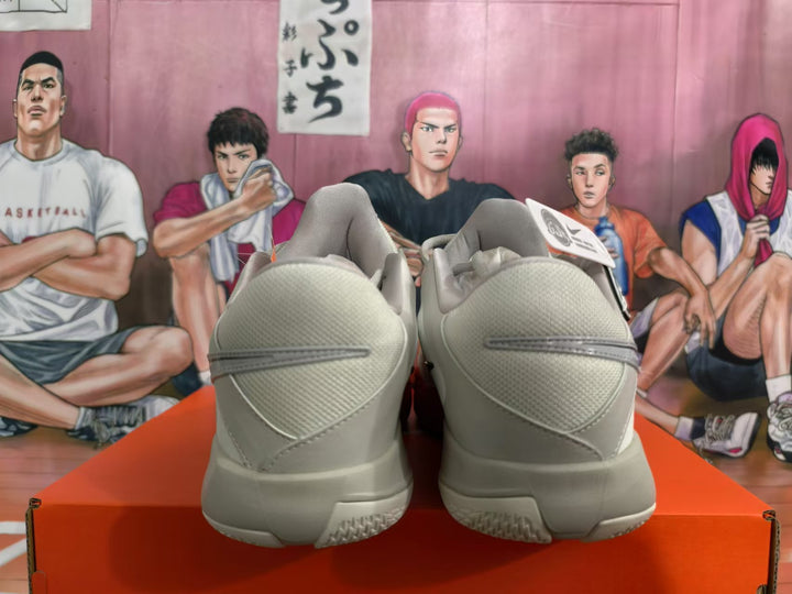 Rear view of white and gray Nike Ja 2 basketball shoes with red accents