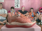 Side profile of a pink basketball-style sneaker showing tonal overlays, textured side panels, laces, and the contrasting outsole.