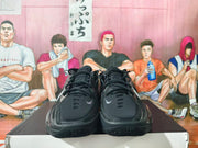 Front view of black Nike basketball shoes with small silver Swoosh details