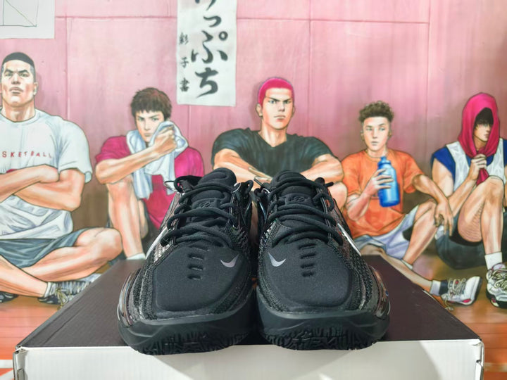 Front view of black Nike basketball shoes with small silver Swoosh details