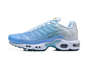 Side profile of a light blue Nike Air Max Plus sneaker showing its wavy panels and cushioning units.