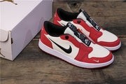 Angled view of the paired sneakers beside a shoebox, showing red overlays, white panels, black Nike branding, and white midsoles.