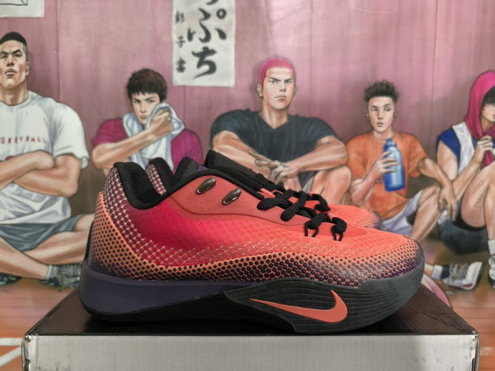Side view of red and black Nike basketball sneakers displayed on a box.
