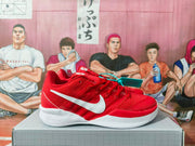 Side view showing the red textured upper, white Swoosh, and white midsole.