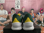 Rear view showing yellow heel panels and white soles on the olive green shoes.