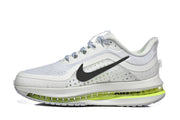Side view of a white and light gray Nike Pegasus Premium shoe with black Swoosh and volt midsole accents.