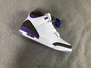 Angled view highlighting the white upper, purple eyelet details, patterned overlays, and visible midsole window.