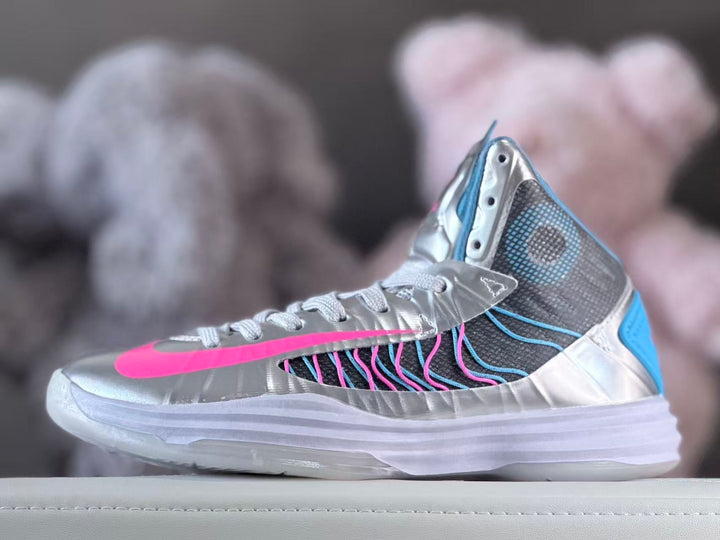 Side view of a silver high-top sneaker with pink, blue, and dark gray accents