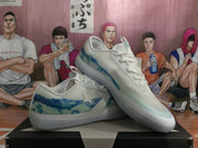 Pair of white and blue low-top sneakers shown from an angled side view on a shoebox.