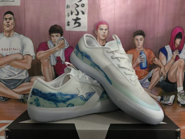Pair of white and blue low-top sneakers shown from an angled side view on a shoebox.