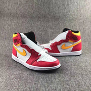 Pair of high-top sneakers shown from a front three-quarter angle with yellow swooshes and red overlays.
