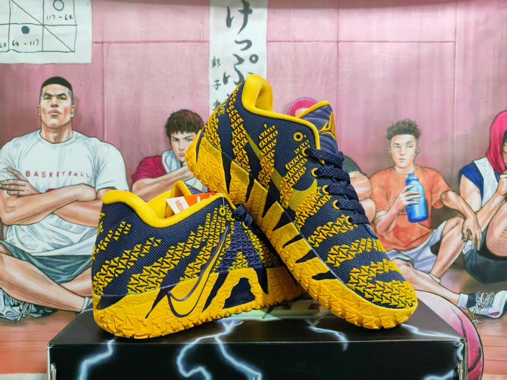 Pair of dark purple and yellow Nike basketball sneakers displayed on a black box, showing the side profile, textured upper, laces, and patterned outsole.