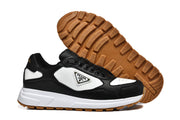 Black and white sneakers shown from the side with the gum-colored tread outsole visible