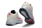 Light gray Nike GT Hustle 3 shoes with coral accents, shown from heel and outsole angles.