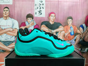 Side profile of a sky-blue Nike basketball shoe with black trim, a pink Swoosh, and turquoise outsole