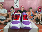 Front view of the white and purple basketball sneakers showing perforated purple toe panels, red laces, white uppers, and Kobe branding on the tongue.