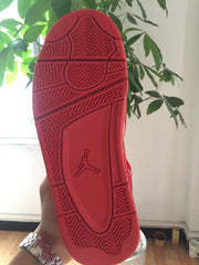 Outsole view of a red high-top sneaker with a patterned rubber traction surface.