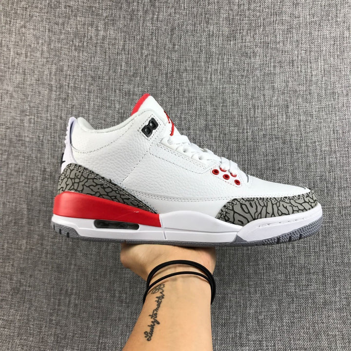 Side view of a white, red, and grey Jordan Air Jordan 3 sneaker