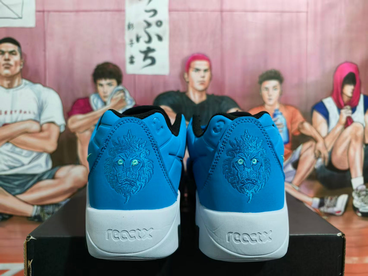 Rear view of blue Nike basketball sneakers showing embroidered lion heel graphics and white midsoles.