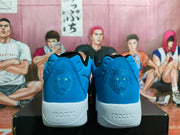 Rear view of blue Nike basketball sneakers showing embroidered lion heel graphics and white midsoles.