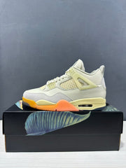 Side profile of a Jordan Air Jordan 4 sneaker with mesh side panel, pale yellow lace supports, orange outsole accents, and a visible heel cushioning window.