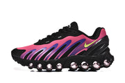 Side profile highlighting the pink and purple graphics and rounded outsole details