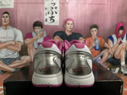 Rear view showing the metallic silver heel panels, pink collars, white midsoles, and signature-style heel graphics.