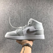 Opposite side view of the white and silver high-top sneaker with a contrasting side emblem.