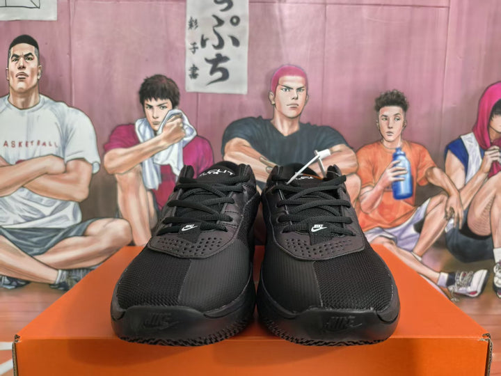 Pair of black Nike basketball sneakers viewed from the front on an orange shoebox.