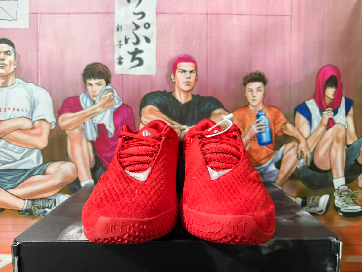 Front view of red Nike basketball shoes with a textured upper and lace-up front
