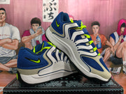 Pair of blue and white Nike sneakers with neon green laces and black outsoles