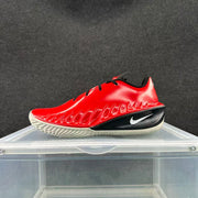 Side view highlighting the shoe’s sculpted red upper and patterned outsole